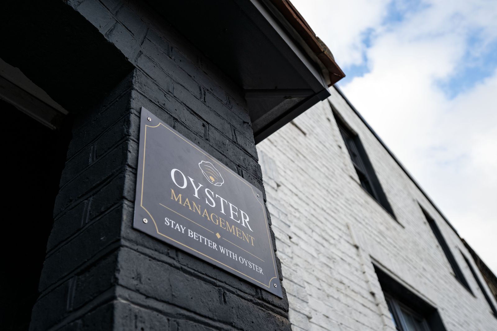 Oyster sign on the dark brick front of Thames House