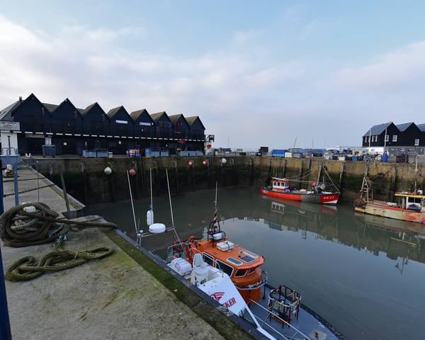 Black huts on Whitstable harbour in winter